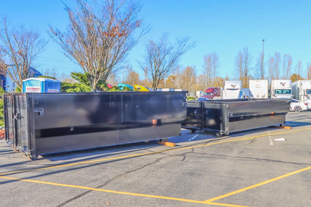 Professional dumpster rental service with roll-off container on residential driveway in Tontitown